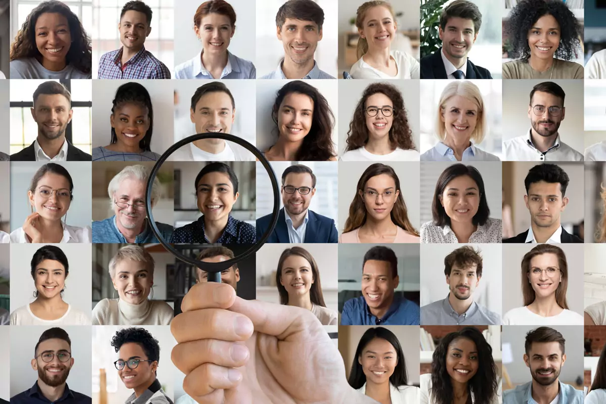 Lots of businesspeople under a magnifying glass.